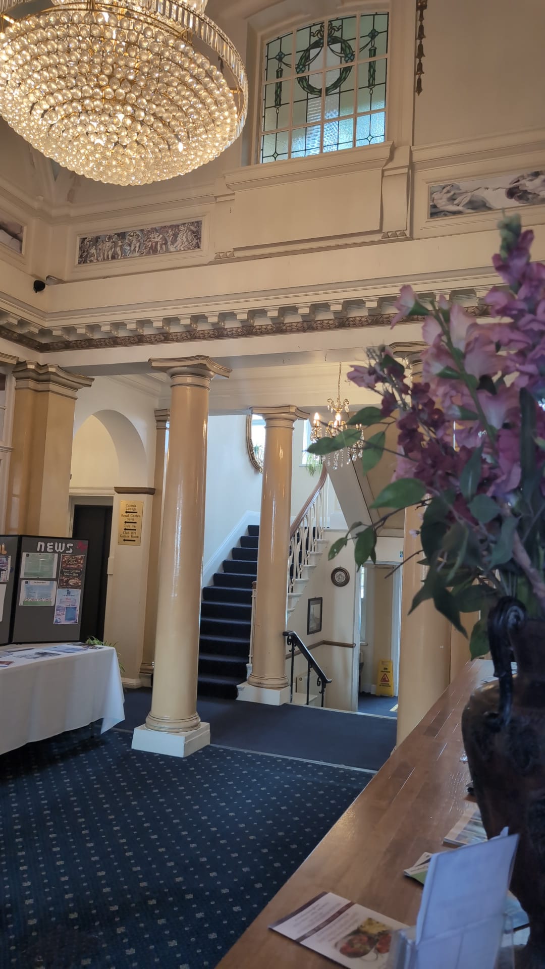 Reception lobby with grand staircase and floral arrangement at The Royal Hotel, Skegness