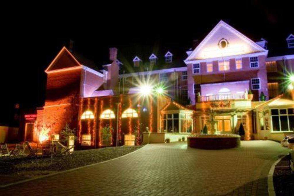 The hotel facade floodlit at night