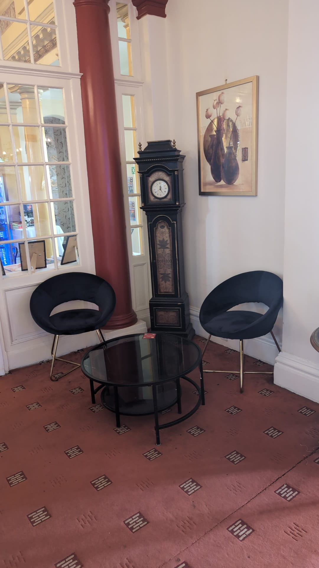 Grandfather clock beside a lobby seating area