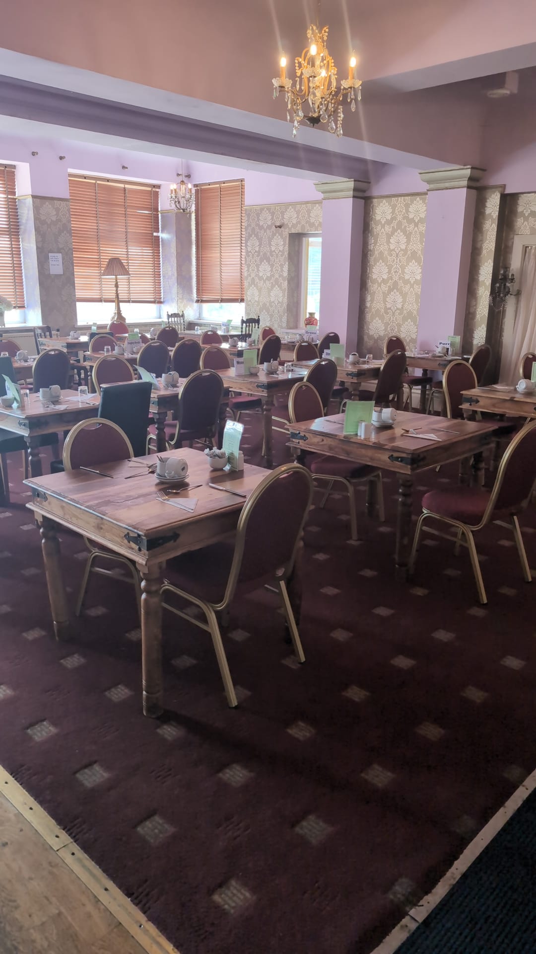 Restaurant tables under damask wallpaper and crystal chandelier - The Royal Hotel, Skegness