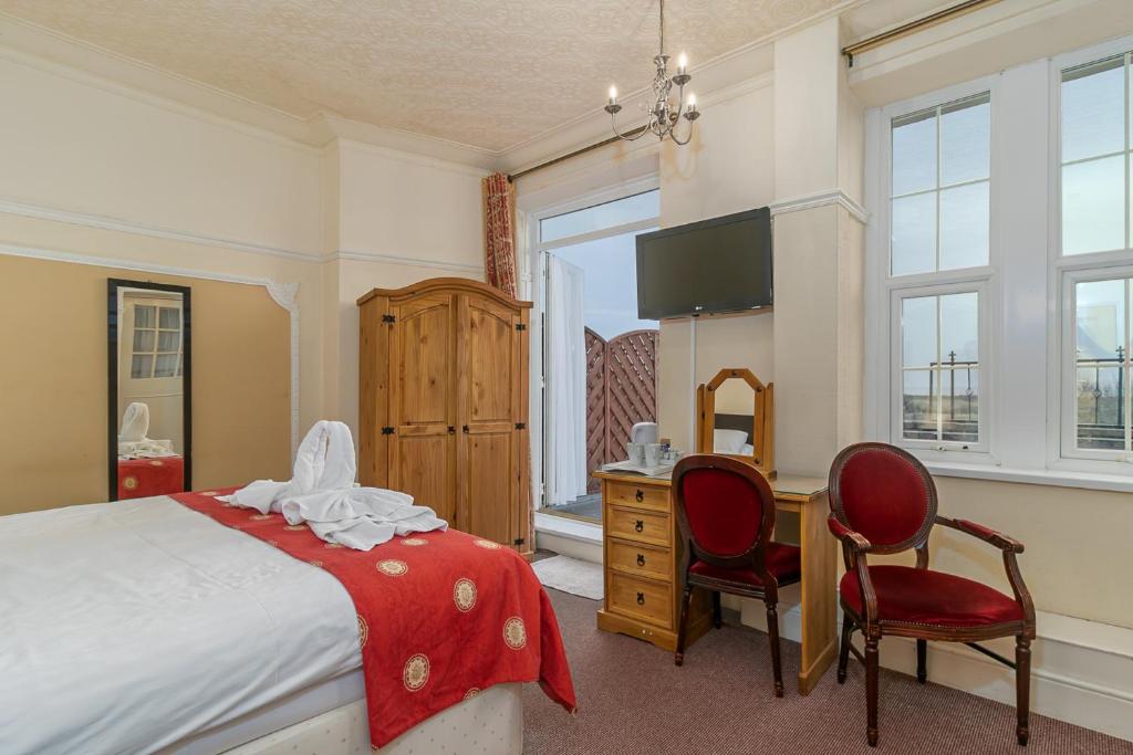 Deluxe room desk beside the balcony doors