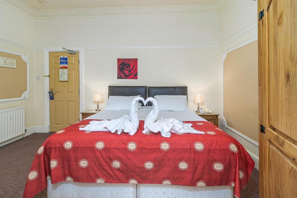 Guest room with swan-folded towels on a double bed