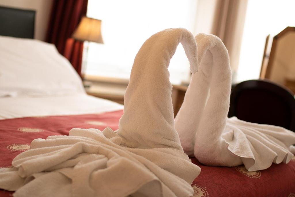 Swan-folded towel arrangement on the bed