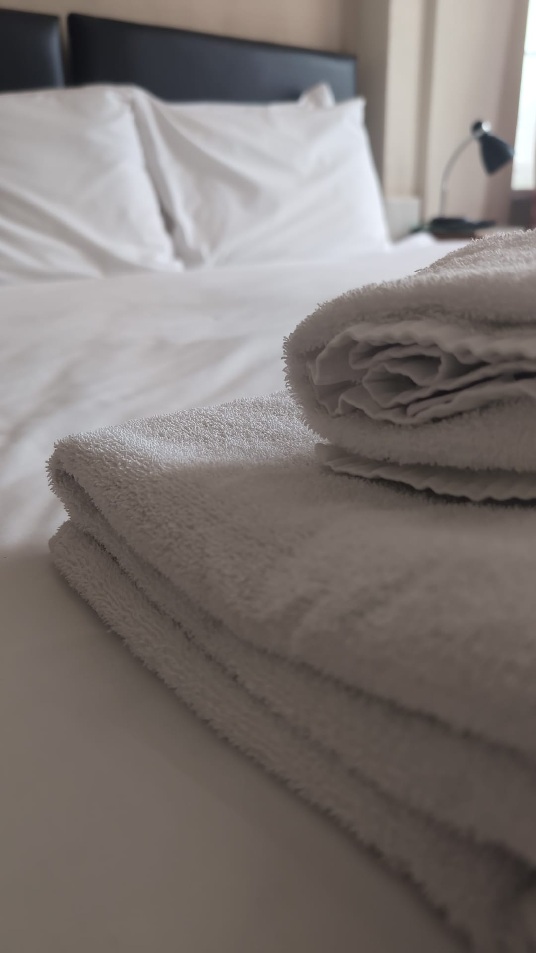 Folded towels on crisp white linen