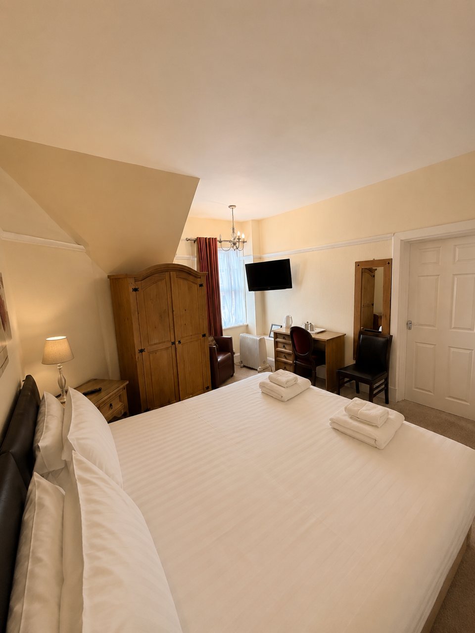 Standard Double Seaview interior with sash window and red curtains